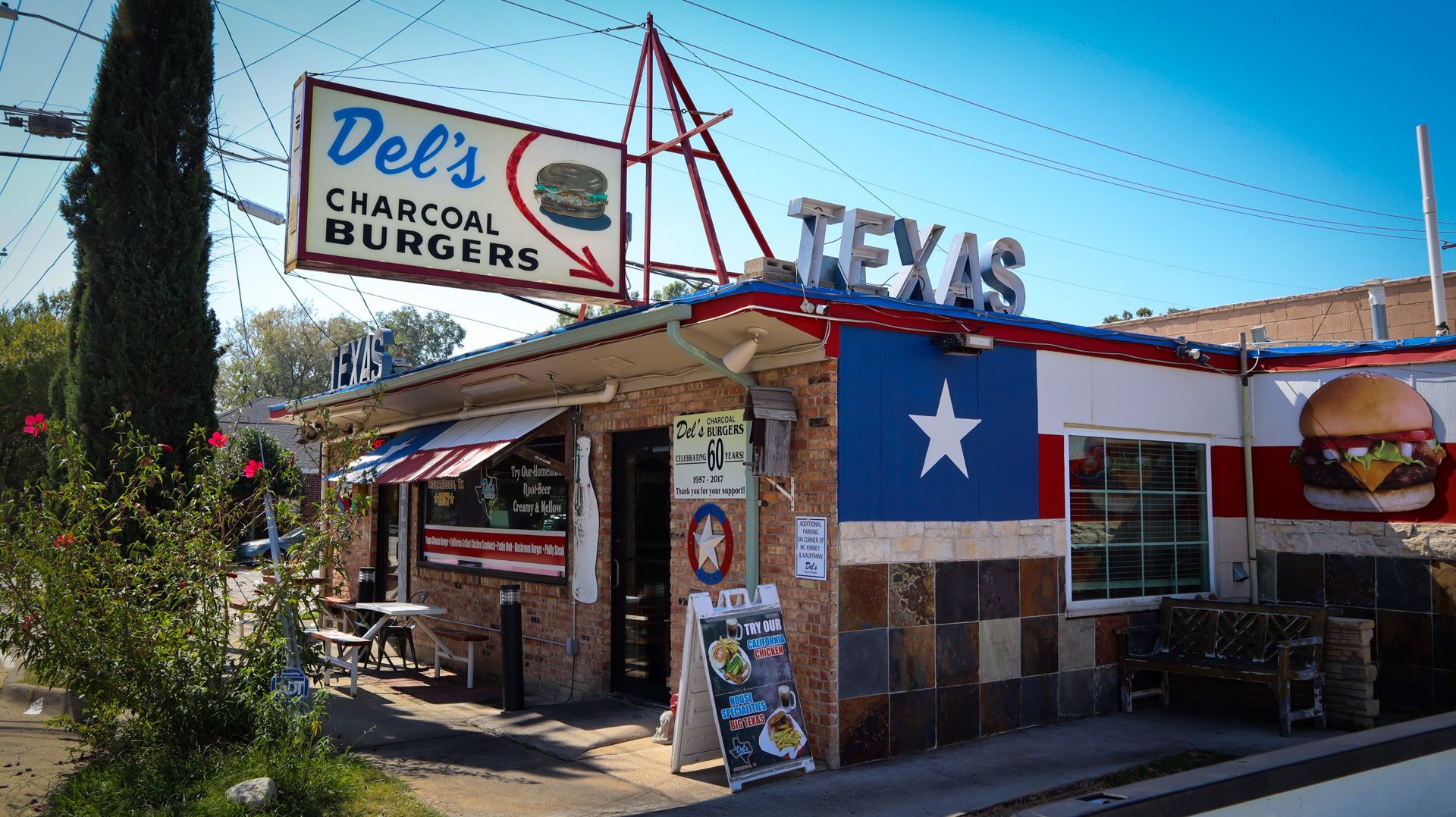 Del's Charcoal Burgers storefront with its Texas flag facade and vintage sign on S. McKinney in Richardson, TX